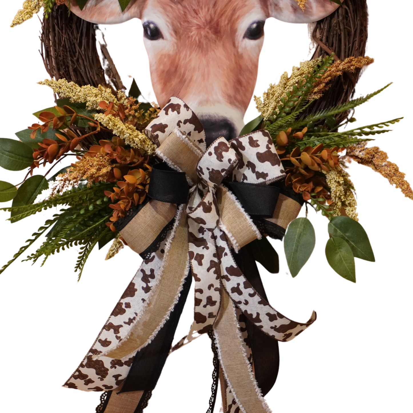 Brown Cow Fall wreath design with cow print ribbon, greenery, Fall florals, and embossed cow sign
