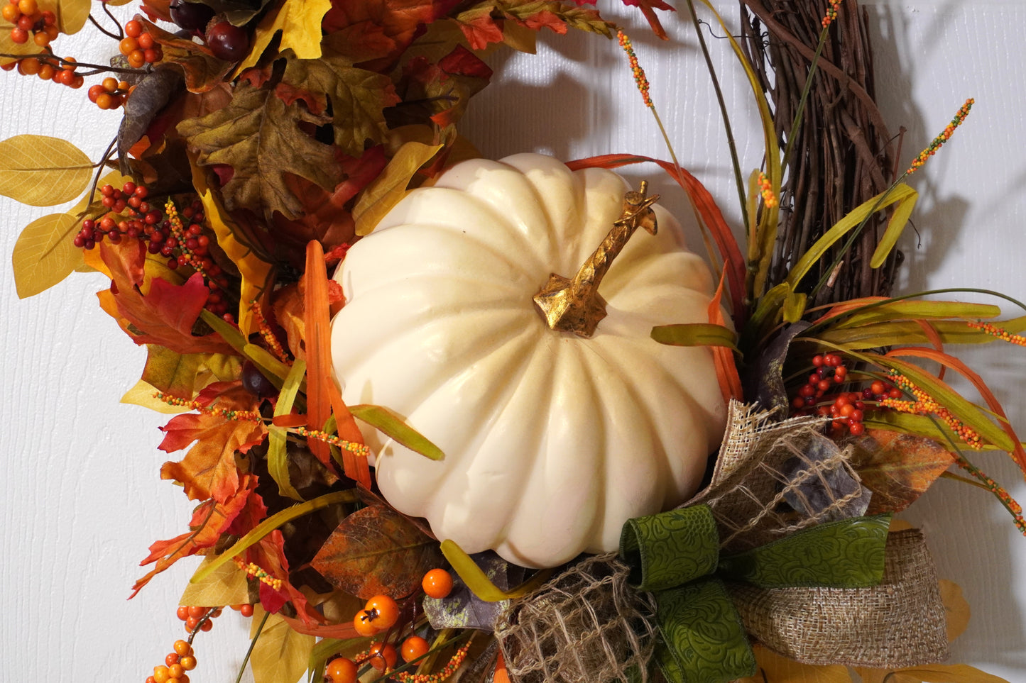 Fall Grapevine Wreath with a Cream colored pumpkin, Fall colored leaves and Berries