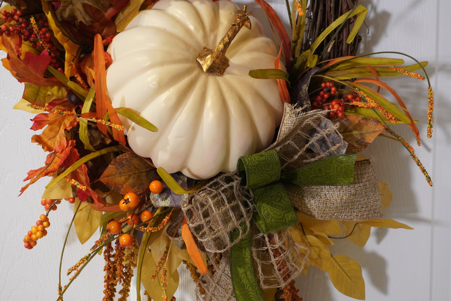 Fall Grapevine Wreath with a Cream colored pumpkin, Fall colored leaves and Berries