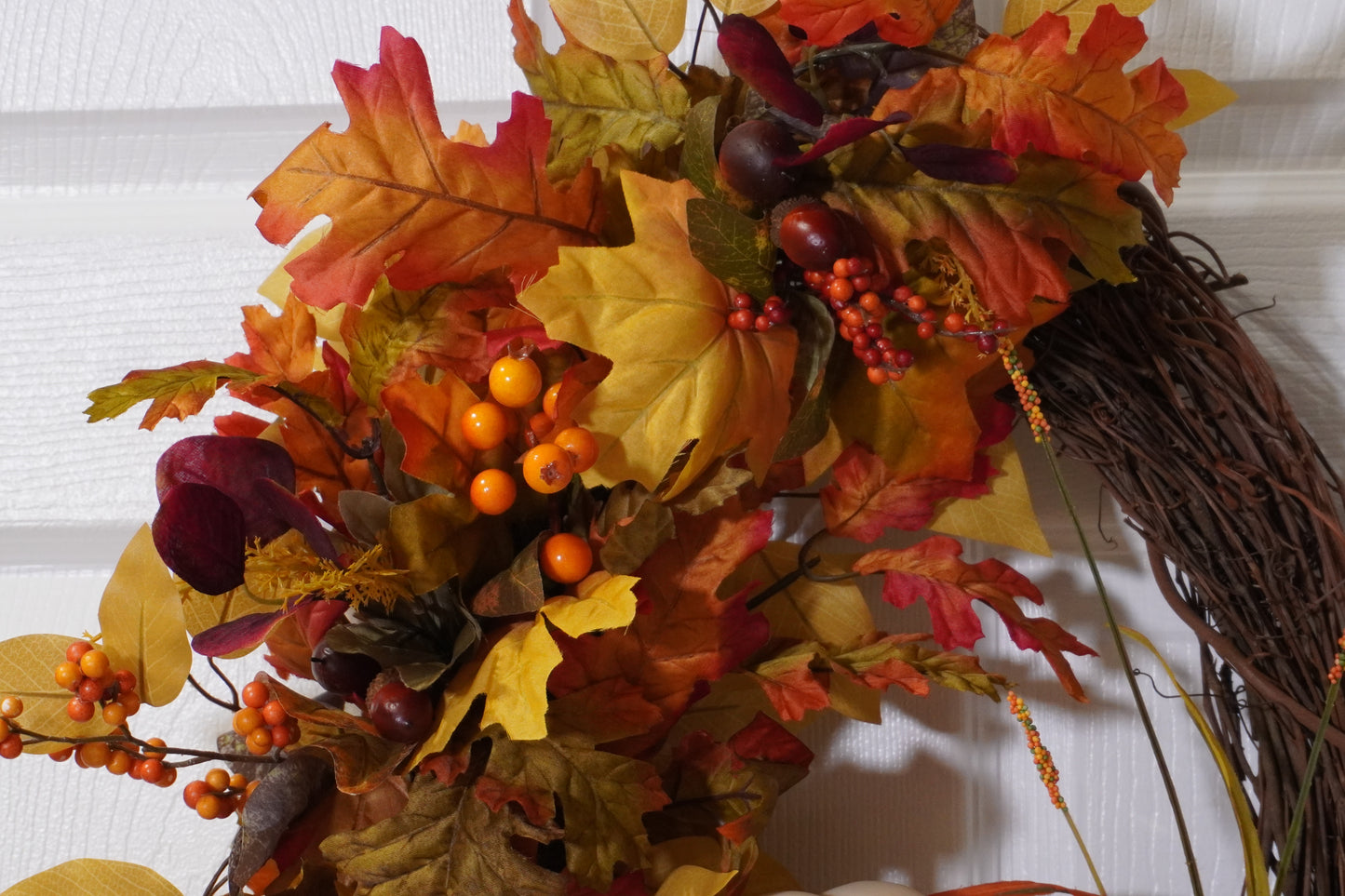 Fall Grapevine Wreath with a Cream colored pumpkin, Fall colored leaves and Berries