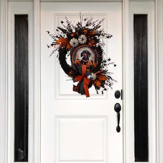 Happy Halloween Weiner Dog themed wreath on a Black Grapevine base the a metal Weiner Dog and Jack-o-lantern sign