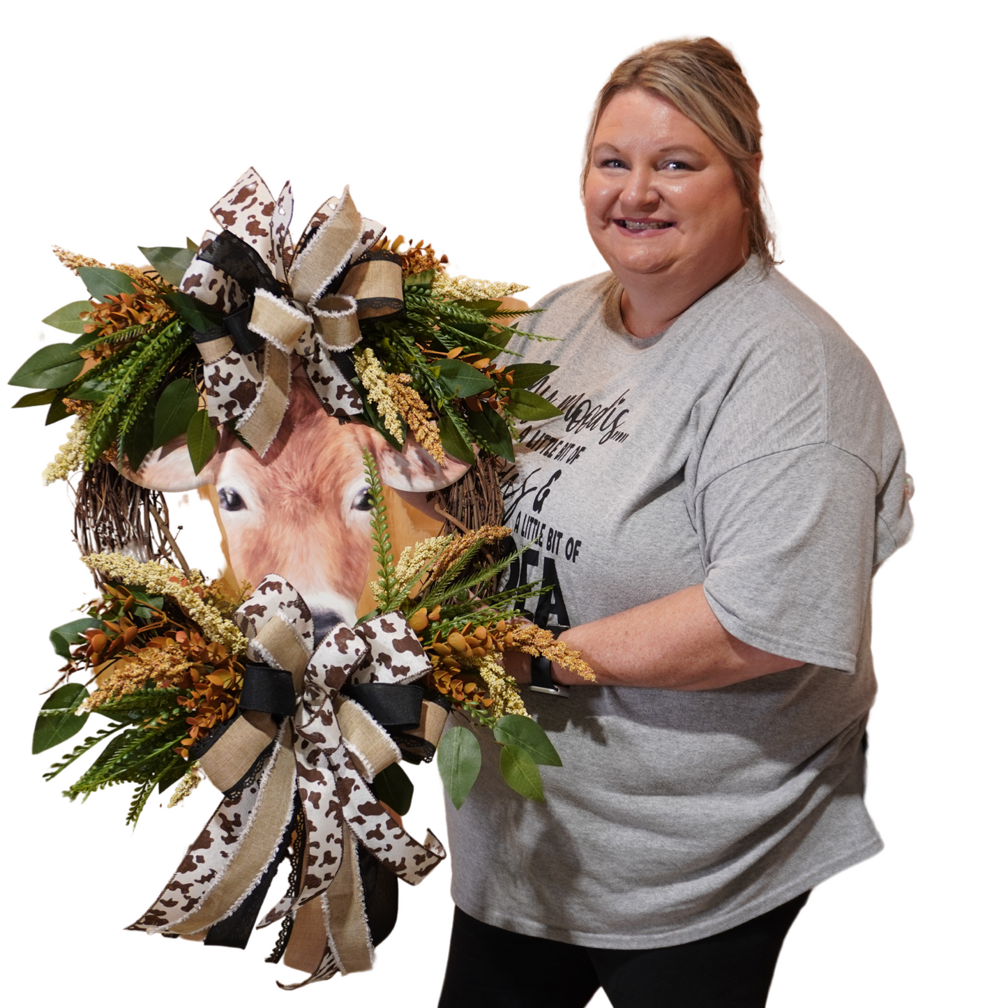 Brown Cow Fall wreath design with cow print ribbon, greenery, Fall florals, and embossed cow sign