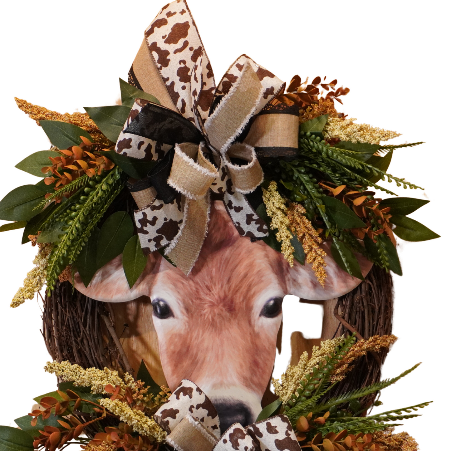 Brown Cow Fall wreath design with cow print ribbon, greenery, Fall florals, and embossed cow sign