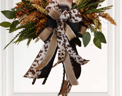 Brown Cow Fall wreath design with cow print ribbon, greenery, Fall florals, and embossed cow sign