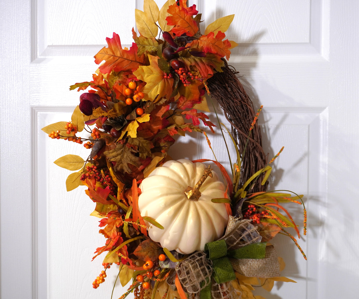 Fall Grapevine Wreath with a Cream colored pumpkin, Fall colored leaves and Berries